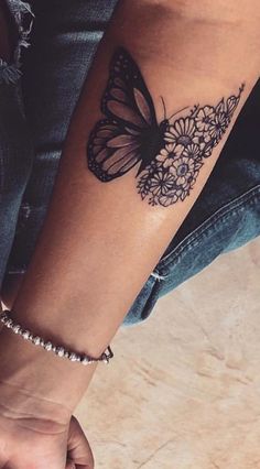 a woman's arm with a butterfly tattoo on it