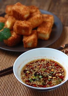 there is a bowl of food on the table with chopsticks next to it