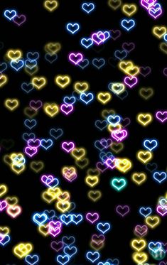 many different colored hearts on a black background