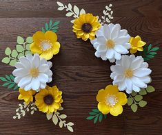 paper flowers are arranged on a wooden surface