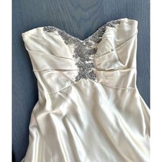 a white dress with silver beading on it