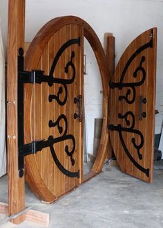 two wooden doors with black iron designs on them