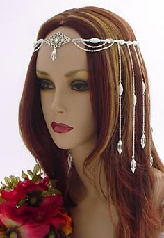 a mannequin headpiece with beads and flowers on it