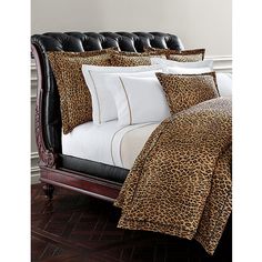 a leopard print comforter set on a bed