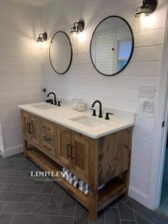 a bathroom with two sinks and mirrors on the wall