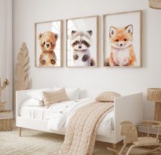 three pictures of animals hanging on the wall in a child's room with white furniture