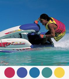 a man riding on top of a jet ski in the ocean