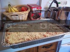 an uncooked casserole in a pan on top of a stove