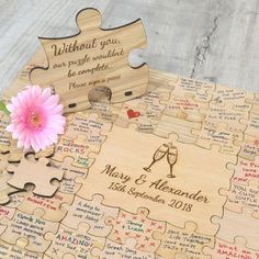 a wooden puzzle with a pink flower on it