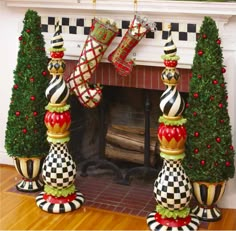 christmas decorations are displayed in front of a fireplace