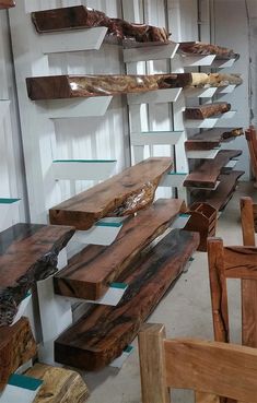 several wooden benches lined up against a wall in a room with glass shelves on each side