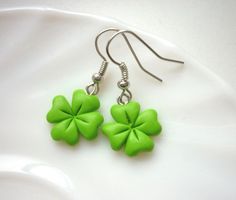 the earrings are green with four leaf clovers