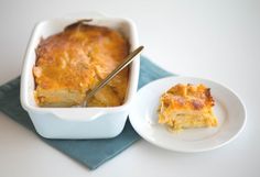 a casserole dish on a plate with a fork next to the casserole