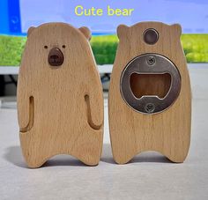 two wooden bear shaped objects sitting next to each other