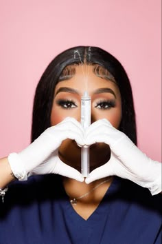 a woman in white gloves is making a heart shape with her hands while holding a sy