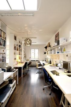 an office with wood floors and white walls