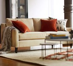 a living room filled with furniture and pillows