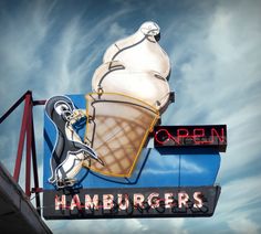 an ice cream shop sign on the side of a building that says open hamburgers