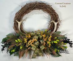 a wreath with deer antlers and flowers on it