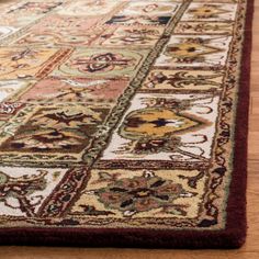 a large rug with many different colors and designs on the floor in front of a wooden floor