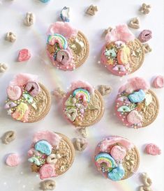 cookies decorated with pastel colors are arranged on a white surface