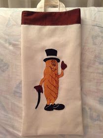 an embroidered bag with a cartoon character on it's side and a top hat