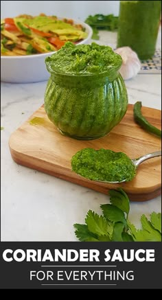 a wooden cutting board topped with green sauce