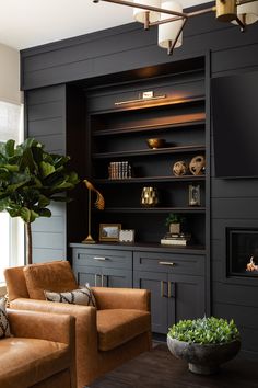 a living room filled with furniture and a fire place next to a wall mounted tv