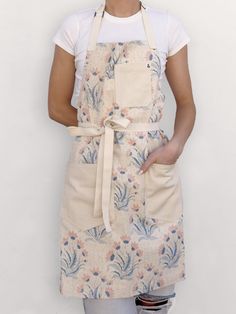 a woman wearing an apron with flowers on it