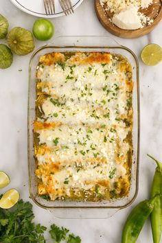 an enchilada casserole in a glass dish on a marble counter