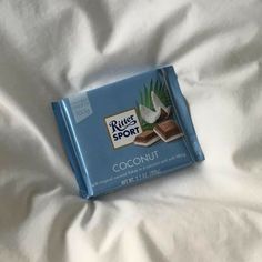 a bar of coconut butter on top of a white bed sheet with the words rules sport written on it