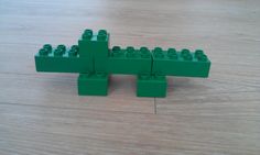 legos are arranged in the shape of a crocodile