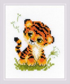 a cross stitch tiger cub sitting in the grass