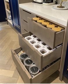 an open drawer in a kitchen filled with cookies