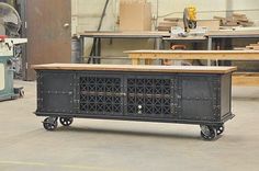 a large metal cabinet sitting in the middle of a room with lots of wood furniture