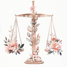 a scale with two flowers on it and one is hanging from the side, while another balances