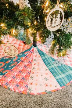 an ornament hanging from the top of a christmas tree with ornaments on it