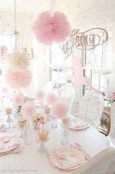 a white table topped with lots of pink decorations