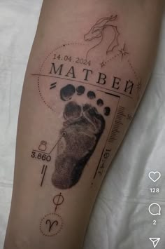 a close up of a person's foot with a tattoo on it