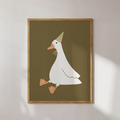 a white duck with a party hat on it's head sitting in front of a wall