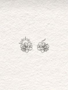 two small flowers are drawn on paper