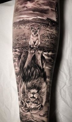 a man's leg with an animal and lion tattoo on the side of his leg