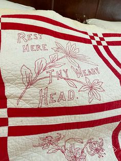 a red and white quilt with writing on it that says rest here, they will be heard