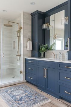 Elevate your bathroom’s style with these chic navy blue cabinets, perfectly complementing the golden fixtures and subtle grey tiles. A touch of greenery adds life to this modern oasis. 🌿💙 #BathroomGoals #NavyBlueChic #ModernHome #InteriorDesign #GoldenDetails #StyleUpgrade” Bathroom Design Blue Cabinets, Modern Bathroom With Blue Vanity, Navy Bathroom Inspiration, Navy Blue Accent Bathroom, Classic Blue Bathroom, White And Dark Blue Bathroom, Elegant Blue Bathroom, Bathrooms Blue Vanity, Bathroom Ideas Blue Tiles