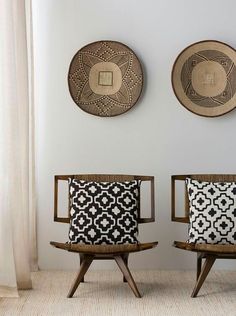 two chairs sitting next to each other on top of a rug