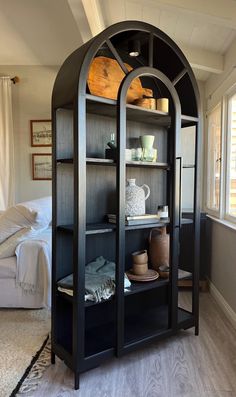 a black bookcase with glass doors in a living room