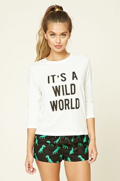 A PJ set featuring a knit tee with a "It's A Wild World" graphic on the front, 3/4 sleeves, and a round neckline, as well as a pair of woven shorts with an allover dinosaur print and an elasticized drawstring waist. Forever 21 Pajamas, White Dinosaur, Dinosaur Graphic, Pineapple Clothes, Girls F, Sleep Clothes, Pajama Outfits, Nightgowns, Fashion Line