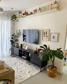 a living room filled with furniture and a flat screen tv on top of a wooden stand