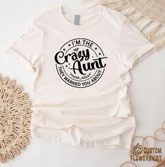 Crazy Aunt T-Shirt, I Am The Crazy Aunt They Warned You About Shirt, New Aunt Gift, Funny Auntie Shirt, Aunt Life Tee, Auntie Humor Tshirt ✨ Thank you for shopping! BEST WAY TO ORDER 1. Select the size(Please make sure to check our size chart) 2. Select the color 3.Add a note to seller when checking out with any special requests UNISEX SHIRTS -Unisex t shirt fits like a well-loved favorite, featuring a crew neck, short sleeves and designed with superior airlume combed and ring-spun cotton-polyester that acts as the best blank canvas for printing. -Features: Side-seamed. Retail fit. Unisex sizing. Shoulder taping. WOMEN VNECK SHIRTS -Fabric: Lightweight Cotton Poly Jersey. -60% Combed Ring-Spun Cotton 40% Polyester / 30 singles, 135 grams/4.0oz. -Binding: Set-in Collar 1x1 Baby Rib with Fro Funny Aunt Shirts, Crazy Aunt, Aunt T Shirts, Aunt Life, Auntie Shirts, New Aunt, Aunt Shirts, Aunt Gifts, Shirt Fits