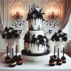 a wedding cake and cupcakes on a table